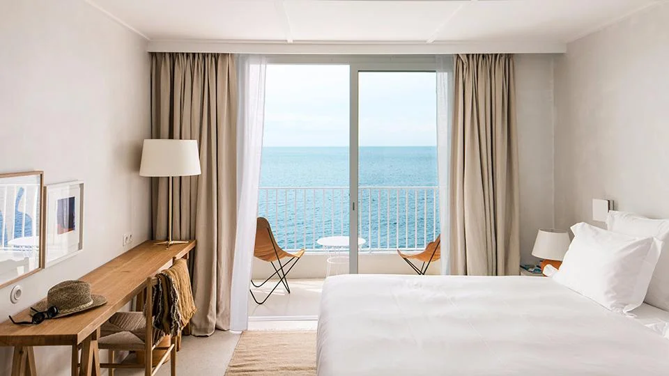 Chambre lumineuse donnant sur une terrasse avec deux chaises et vue directe sur la mer Méditerranée - Appart Hôtel Collioure - Les Suites Collection